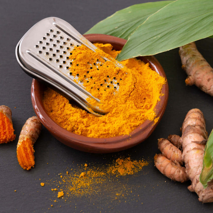 Antiinflamatorio para Perros y Gatos con Vitaminas y Cúrcuma - balukaVIT, cúrcuma en polvo en un tazón.